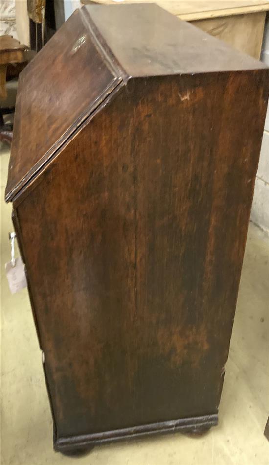 A mid 18th century oak bureau with well, width 92cm, depth 46cm, height 99cm